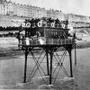 Historic photograph of the Brighton and Rottingdean Seashore Electric Railway “Daddy Long Legs” travelling along the coast with passengers on board.