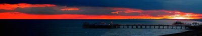 Sunset over the sea showing Brighton and The West pier (PRINT) by unkown