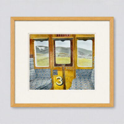Interior of a vintage train carriage by Eric Ravilious, showing patterned blue seats, wooden paneling marked “3”, and countryside hills with a chalk horse visible through the windows.